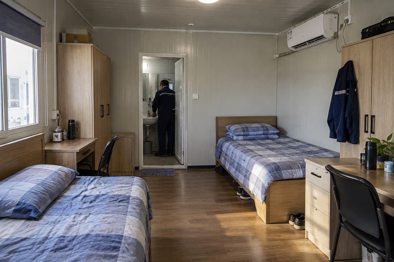 Completed modular accommodation room with two beds, wardrobes, desks and bathroom access