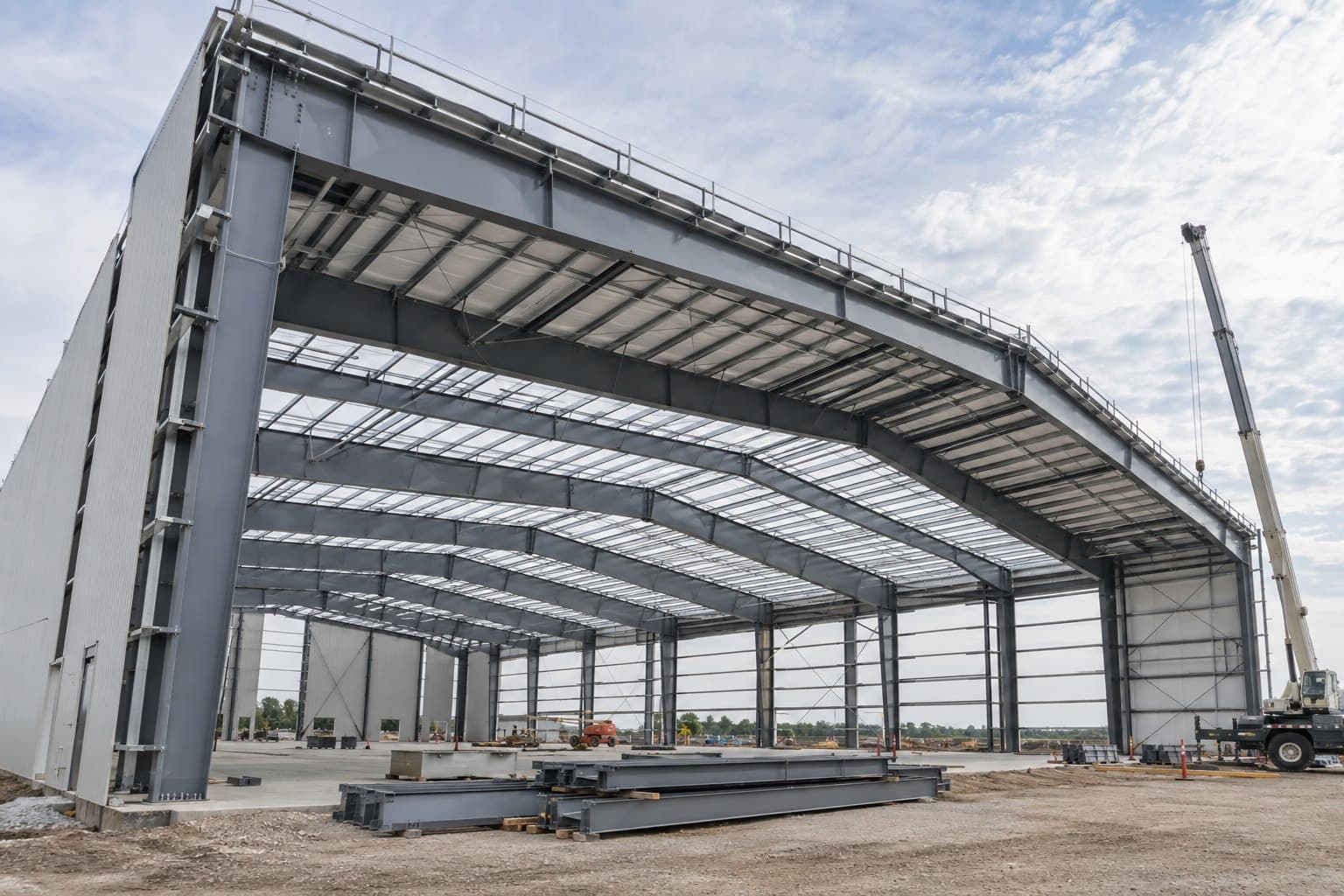 Wide-span steel aircraft hangar frame under construction