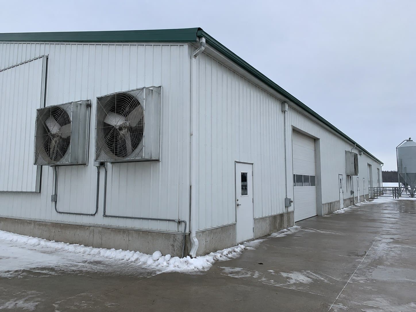 Insulated livestock barn in a cold rural climate