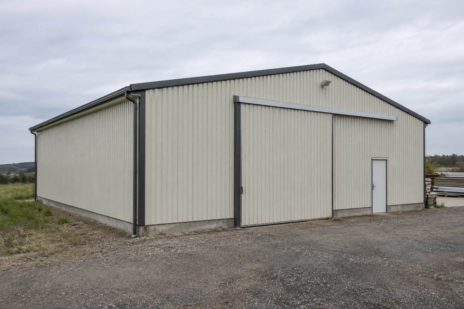Simple single-span prefabricated steel building on a semi-rural site