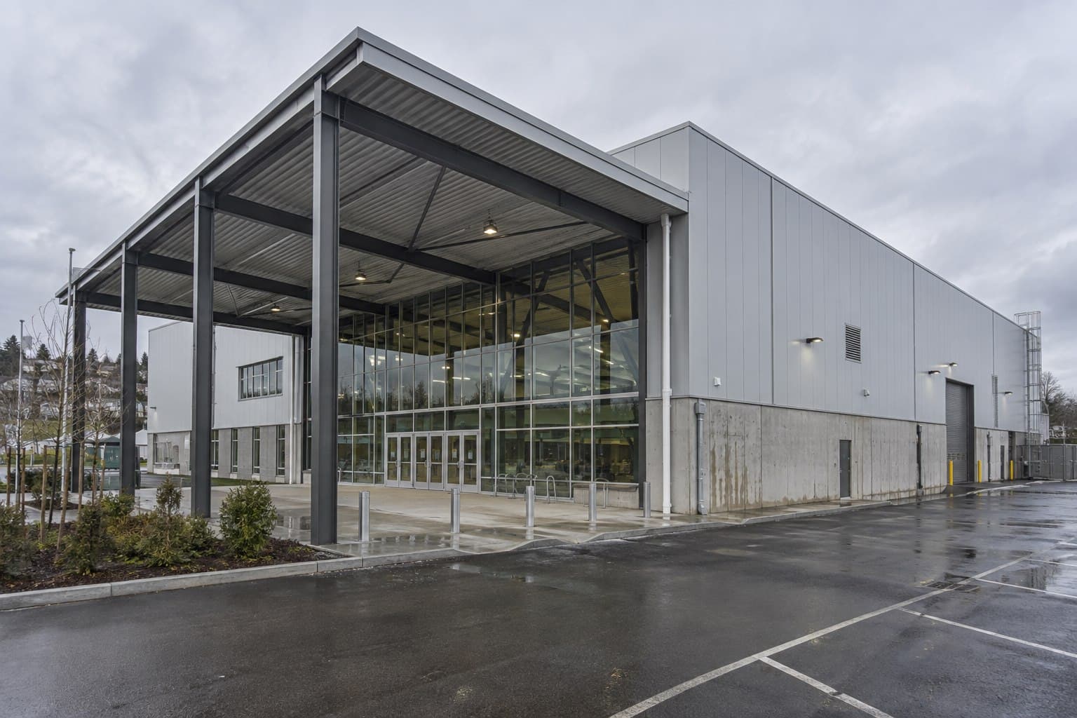 Completed steel-framed civic and industrial building with glazed entrance and canopy