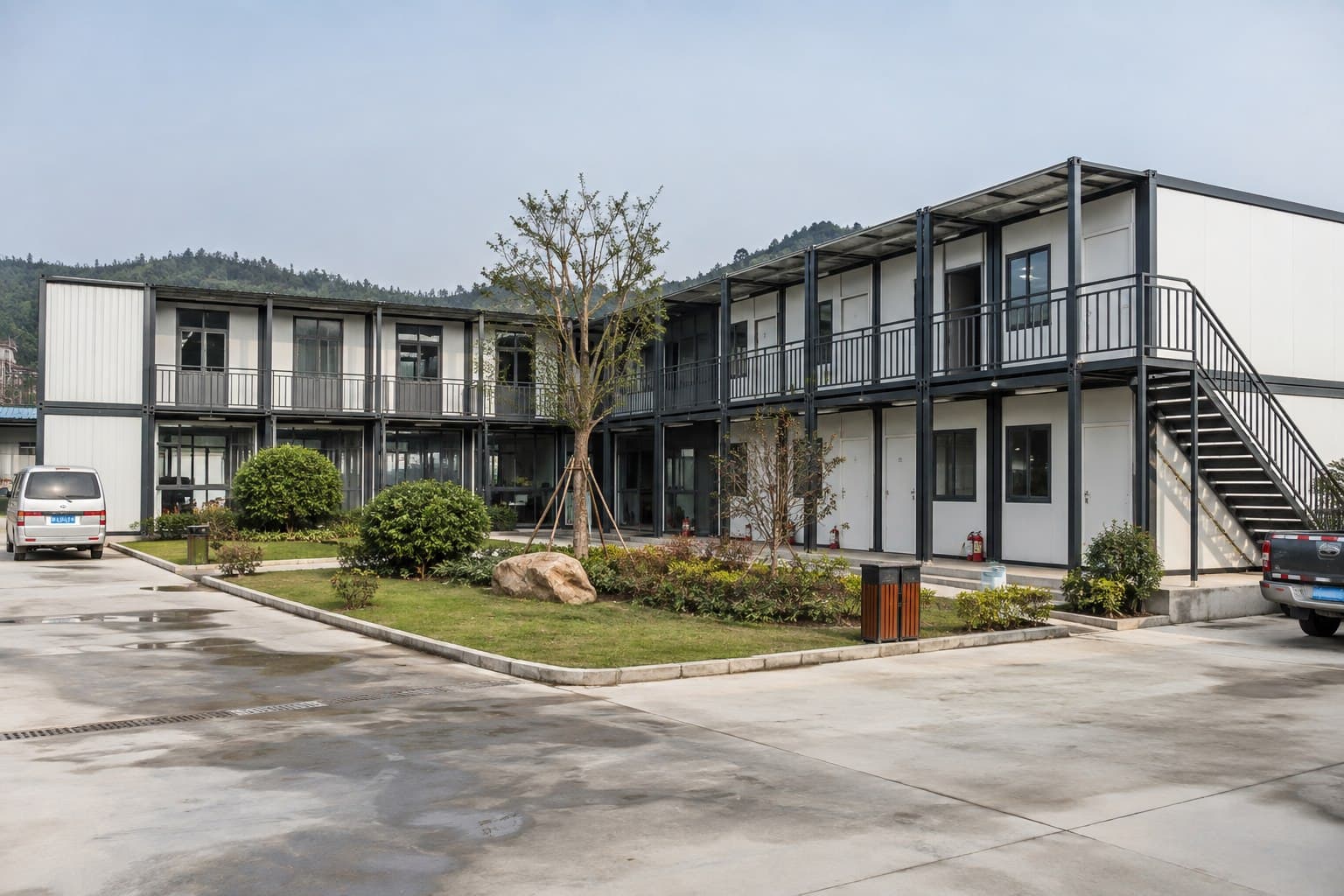 Completed remote workforce camp with rows of modular container houses and a central pedestrian route