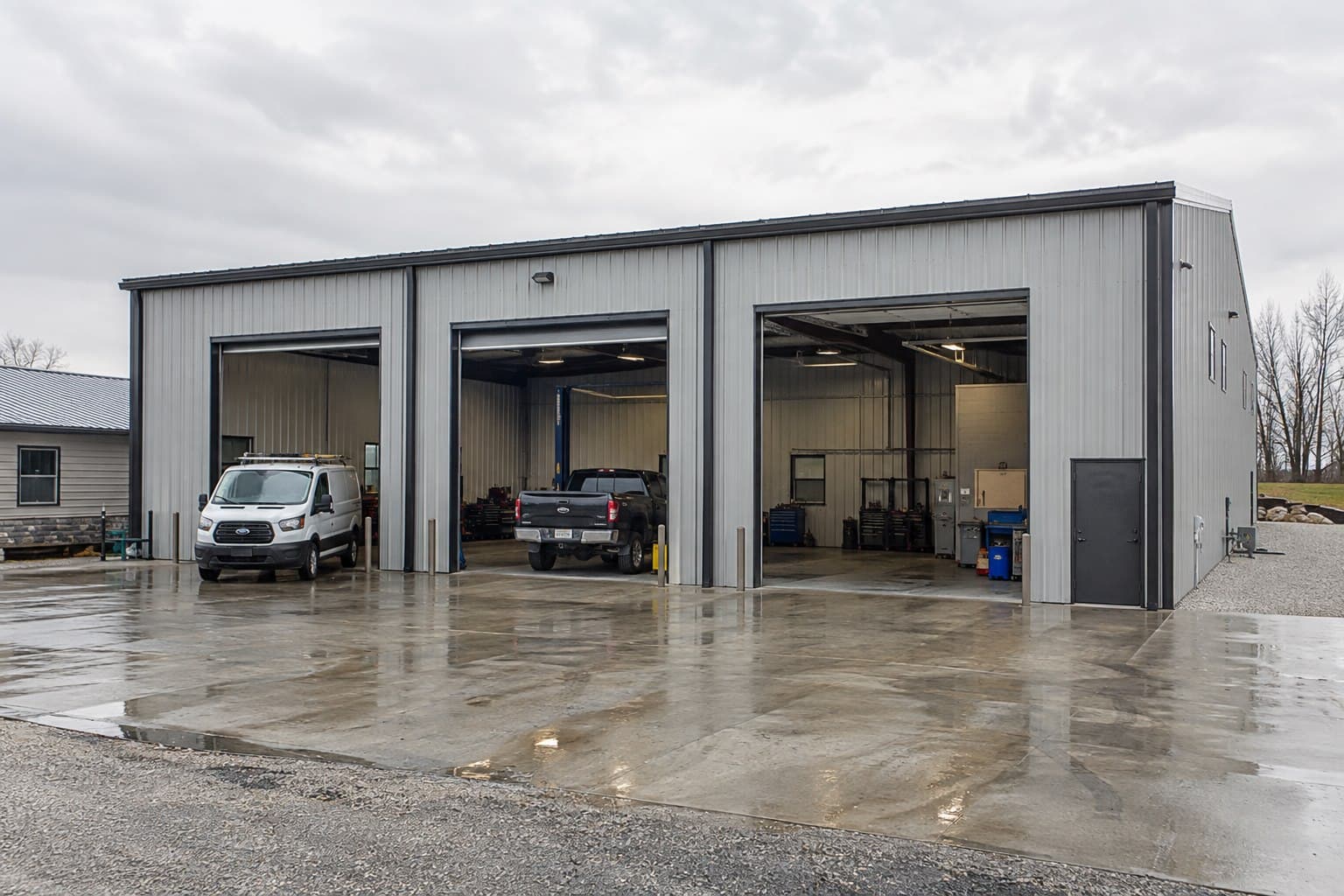 Completed three-bay metal garage photographed at an industrial site