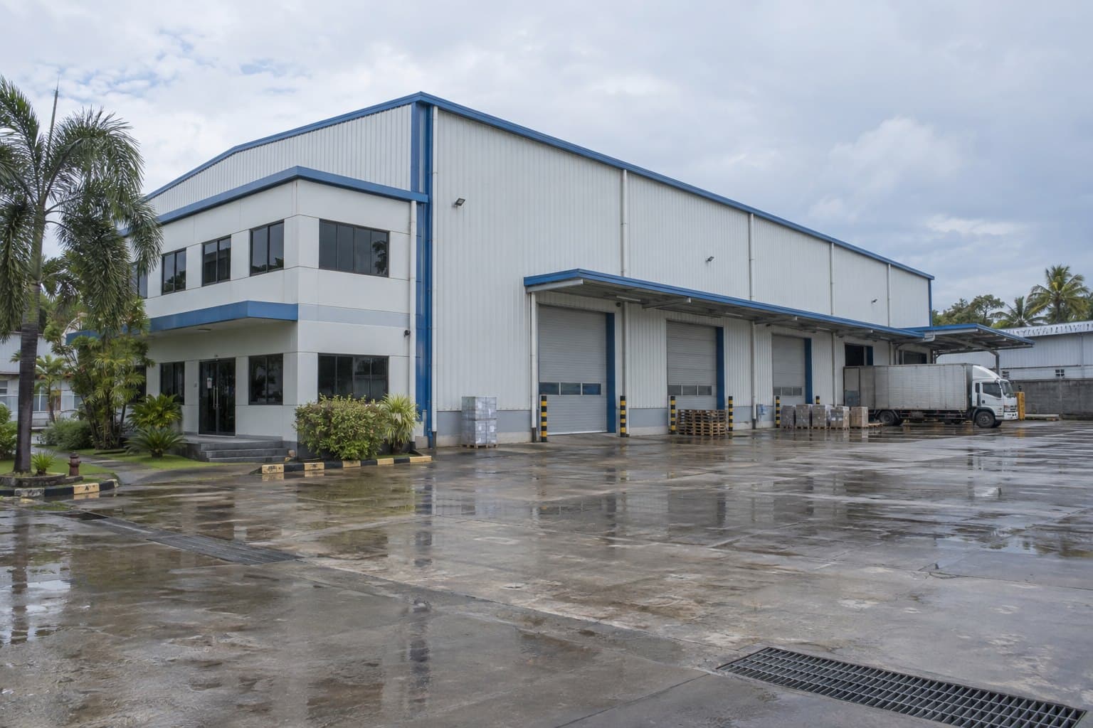 Completed prefabricated warehouse and office building after rain